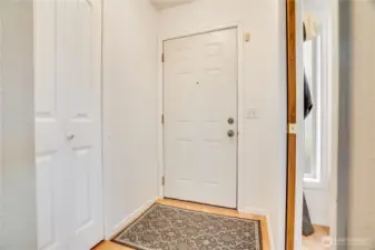 Now that we've given a short preview, let's start at the very beginning. Come in through the front door to this entry with a coat closet on one side, and a pocket door leading to a small front room on the other.