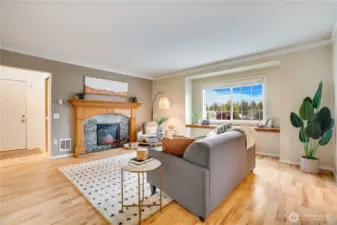 This living room is the seller's favorite room in the house with its electric fireplace and bay window.