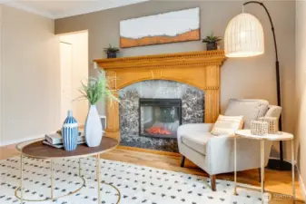 The light from the window and glow from the fireplace make this a cozy room for all seasons.