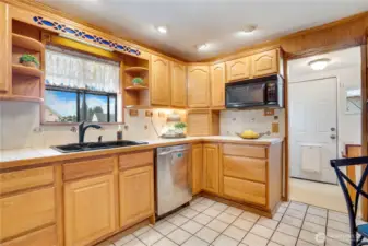 The cabinets include open shelving, a built-in wine rack, and corner rack for displaying plates as well.