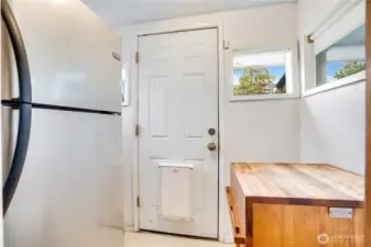 The bright, enclosed back porch has room for a fridge and butcher block. Outside, raised beds are just around the corner for fresh lettuce, tomatoes, basil, kale, or whatever you like to grow.