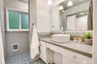 The full bath includes a decorative tiled floor, a vanity with storage, a vessel sink, and pendant lights.