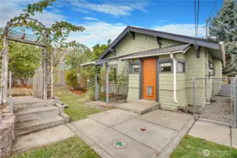 Take the back door out from the kitchen to access the stairwell to the basement. Or step around to the side garden where raised beds wait below the kitchen window.