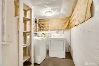 You'll find a laundry area and the water heater on the right at the bottom of the stairs.