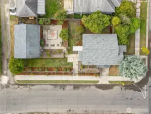 The 6,240 square foot lot includes a 2-car detached garage. Notice the terraced rose garden bordering D Street and the raised beds beside the kitchen for growing veggies, flowers, and herbs.