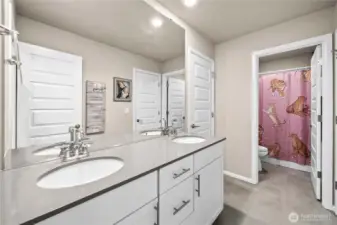 Jack and Jill bathroom with double sinks and separation between the bathtub for multiple people using it at once!