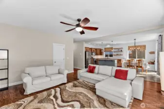 The open living room and kitchen.The door in this photo opens to a spacious under stairway storage area.