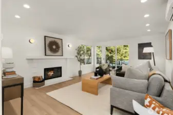 Real wood burning fireplace leads to the deck with downtown views.  Minisplits keep the area cozy or cool depending on the season. AC for all.