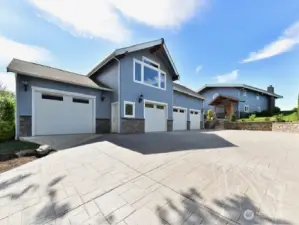 Stamped concrete driveway and 4 car garage.  DADU located above garage.