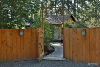 The property is fully fenced with a custom cedar and wire fence providing privacy, keeping the deer out, and allowing a peek-a boo-view of the water.