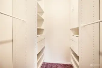 The walk-in closet offers custom built storage.