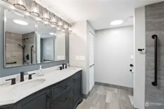 Primary bath offers an updated vanity with dual sinks and linen closet.