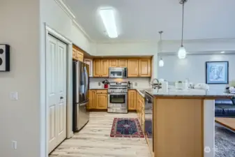 Modern kitchen with granite counters, easy-care floors, lots of storage space - including a pantry.