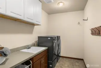 Huge laudry room with sink and cabinets!