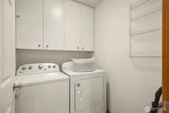 The laundry room on the main floor features plenty of storage.