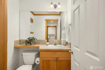 Main floor powder room is tucked away for privacy for guests.