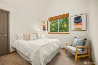 Second upper floor bedroom with vaulted ceilings and walk-in closet.
