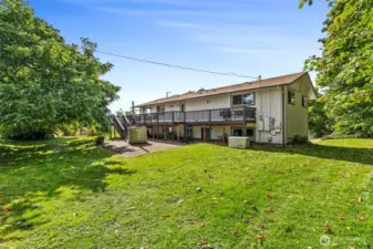 Large entertaining deck provides access to lower patio and back yard/acreage beyond. Don't miss the on-demand generator. Wood-fired hot tub on patio makes a great place to soak away cares, gaze at the stars.
