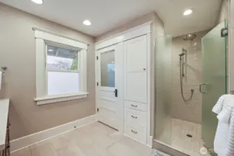 Primary bath upstairs with double vanity and huge shower space and storage.