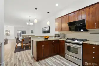 Kitchen with granite counter top, gas range and Robam Range Hood