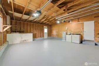 The home has an oversized two-car garage where the washer/dryer and a workbench is located.