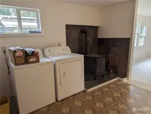wood stove and laundry area