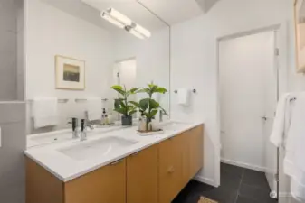 The bathrooms maintain a consistent level of luxury including Abodian cabinetry, quartz countertops, ceramic tile floors, and Grohe WaterSense fixtures, reflecting a commitment to quality and sophistication that runs throughout the home.