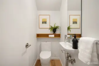 The main floor powder room adds both style and convenience, providing a tasteful and accessible amenity.