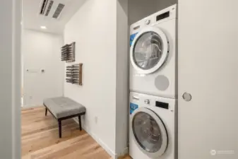 The Bosch stackable EnergyStar washer and dryer are conveniently located in the hallway on the main floor, offering ease of access and efficient laundry care without sacrificing valuable living space.
