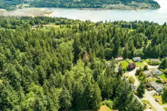 Aerial view with coastline. Lot includes community water access and beach amenities.