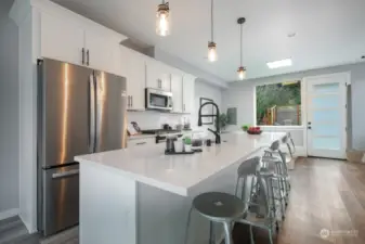 Chef's kitchen with stainless steel appliances and a gas stove.