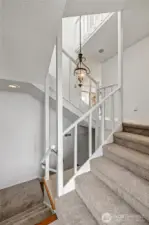 Entry landing at the front door, and the stairs down lead to the 2 car garage. New carpet throughout that was installed just before listing day