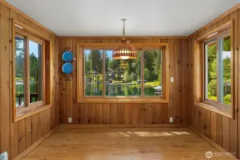 Dining room framed by windows creating abundant natural light and views.