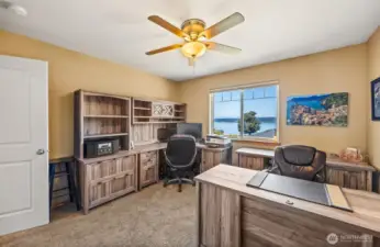Need a home office with a view? This versatile main-floor bedroom delivers—part of a thoughtful layout with three bedrooms and two full baths on the main level.