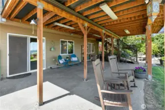 A weather-protected patio beneath the Tek Dek deck is outfitted with custom dimmable lighting for all-weather relaxation and entertaining.