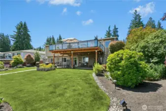 A custom pond and peaceful water feature add calming sound and visual serenity to the garden’s ambiance.