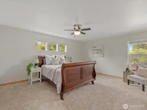 Upstairs, the massive primary suite serves as a private retreat.