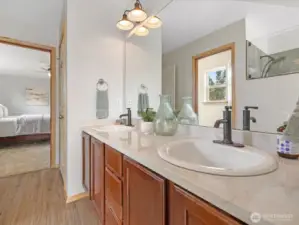The en suite bathroom is generous in size, offering dual vanities, soaking tub, separate shower, and a large walk-in closet.