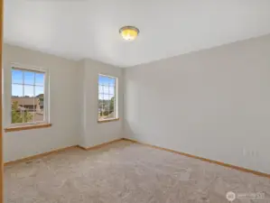 Two more oversized bedrooms upstairs provide plenty of room for family, guests, or home offices.