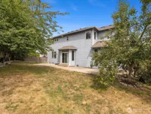 The yard is both private and low-maintenance, providing plenty of room for summer barbecues or evening gatherings under the stars.
