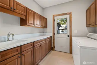 laundry/mud room with fenced off dog run outside