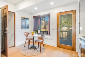 In-kitchen breakfast nook, bay window and access to the back deck and fenced yard.