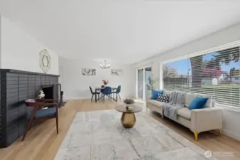 Large windows looking out onto the large level lot with alley access. Sliding door leads to the back patio.