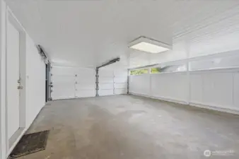 Large carport/garage is freshly painted and also has storage closets and a shop!