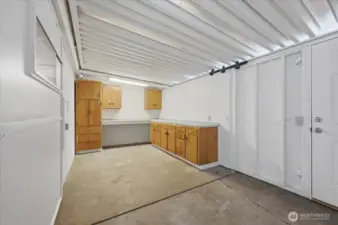 Shop area adjoining the garage/carport. Door leads to the large level backyard.