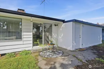 Back patio area off the living room.  Door on the right leads into the shop area off the carport/garage.