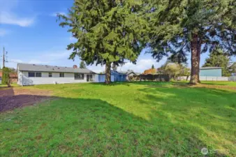 Large level backyard is fully fenced and offers alley access in back.