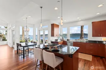 Almost every room in the home was designed to showcase the views.  The kitchen features cherry cabinets and granite countertops.  The Brazilian Tigerwood floors are a great complement to the gallery white walls and bright exterior views.