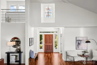 The entry showcases the way afternoon light from the west fills the spaces.  The custom fabricated metal railing system is a work of art all to its own and definitely a centerpiece of the home's interior design.  (The grand piano previously resided in the nook pictured on the right)