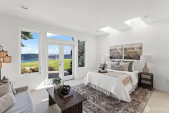 Designed for long term living / forever home, the primary bedroom is on the main floor, featuring french doors to the patio and its own sitting area.